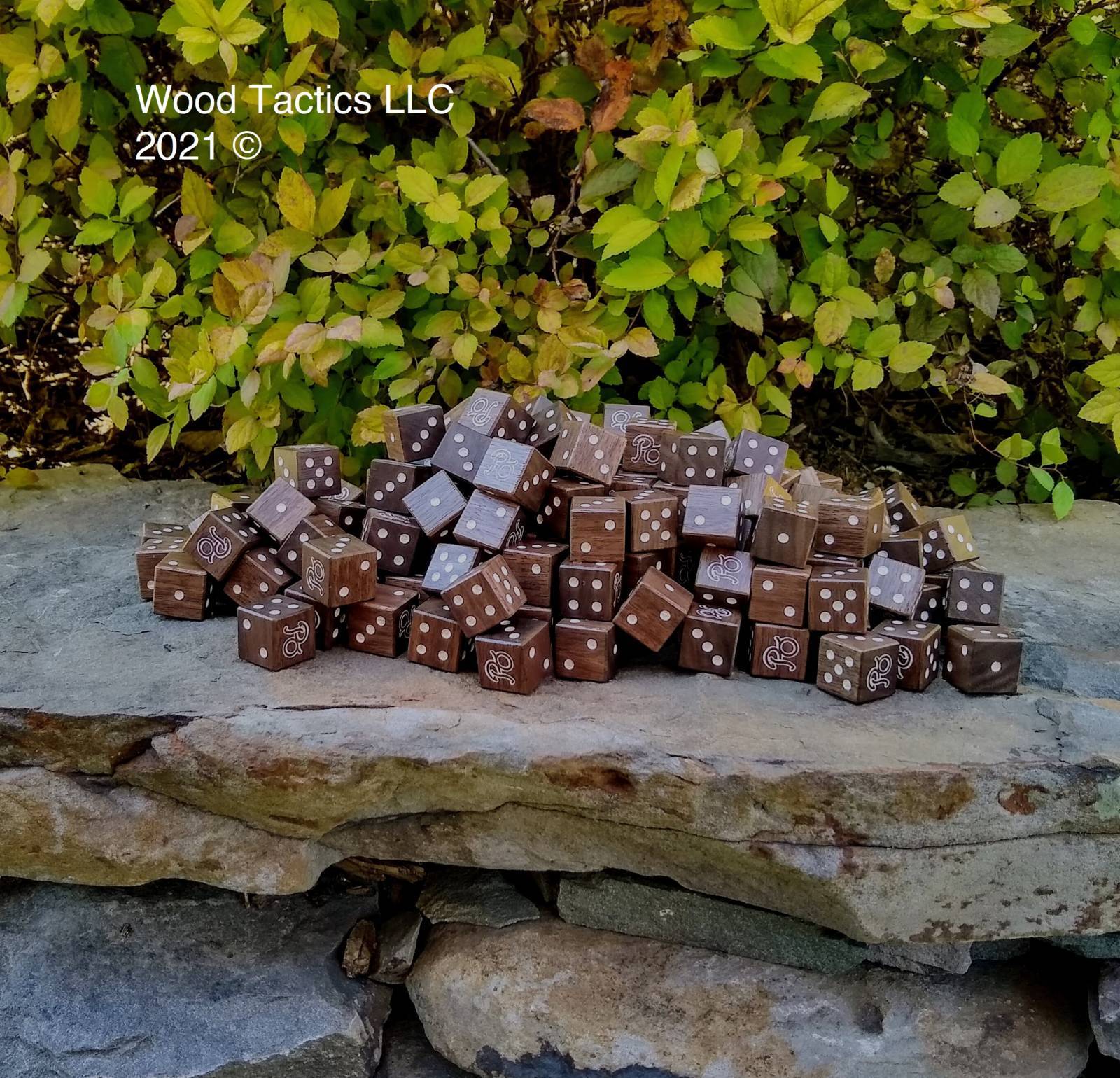 Custom d6 made from Walnut Hardwood with white Ink. This is for Paradise-Opoly Kickstarter.