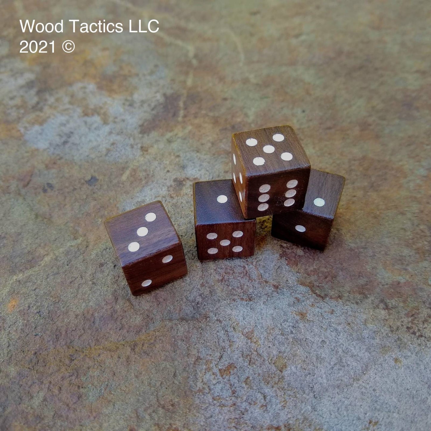 Walnut Hardwood D6 16mm in size Dice with Pip Symbols. Symbols are inked in white.