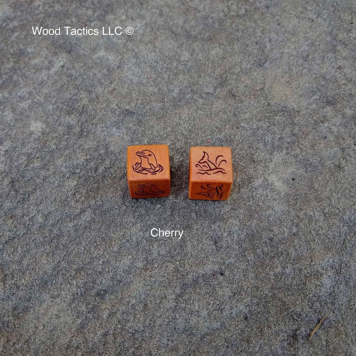 Cherry Hardwood D6 Coin Flip Dice with A Dolphin head above the water and a dolphin tail above the water on the opposite sides.