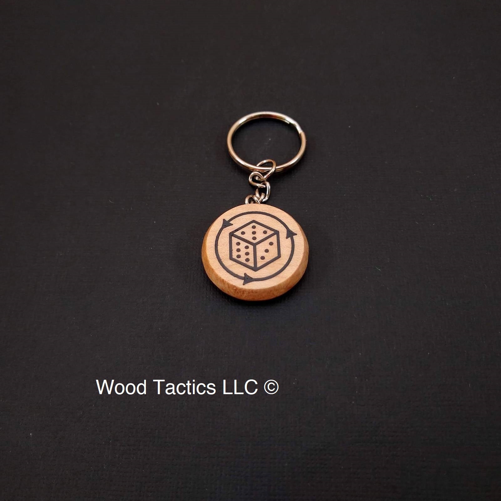 Custom Keychain with a 30mm round token with a d6 design on it made from Maple Wood.