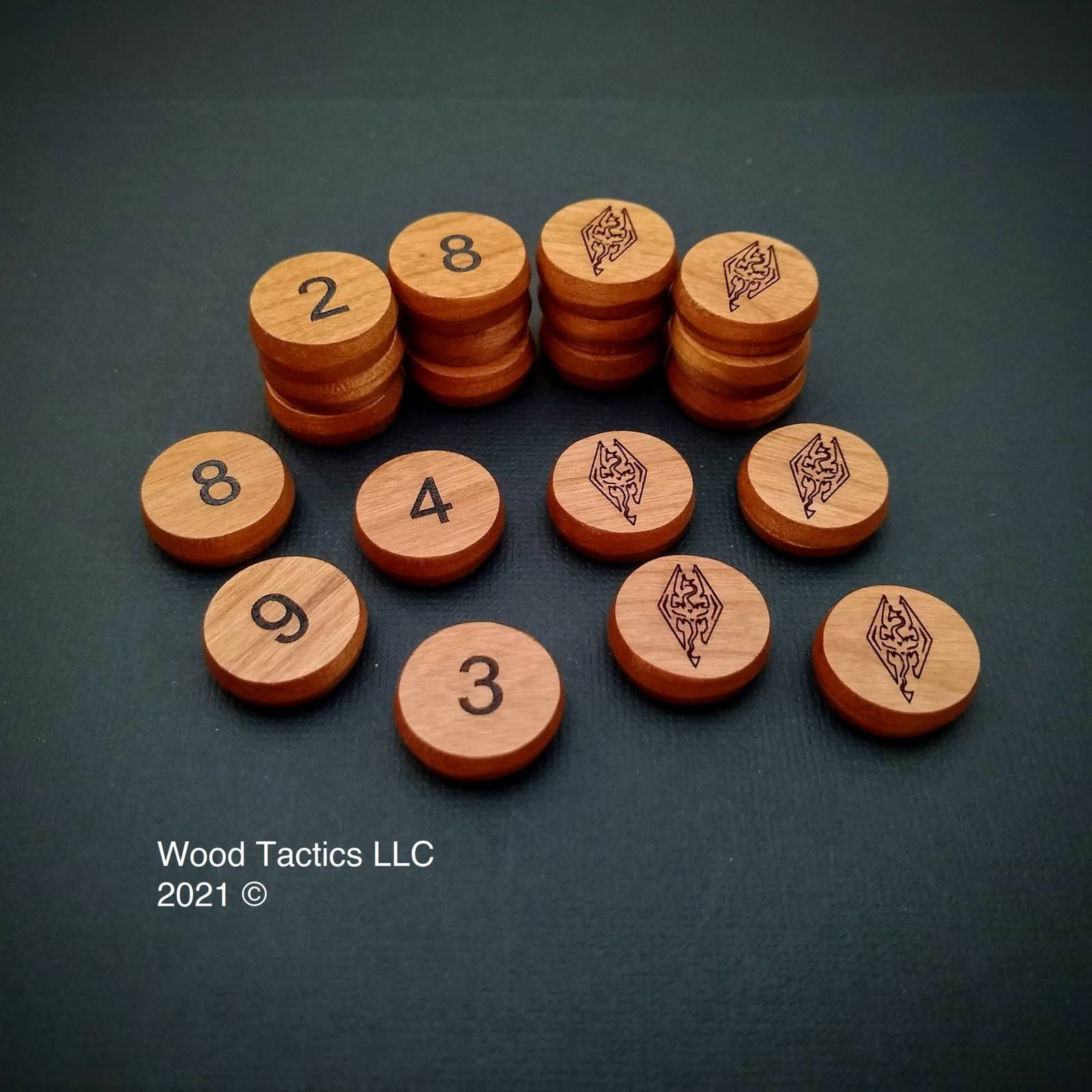 Custom 20mm Round tokens made from Cherry. Side one has the skyrim symbol and the other a number 1-10.