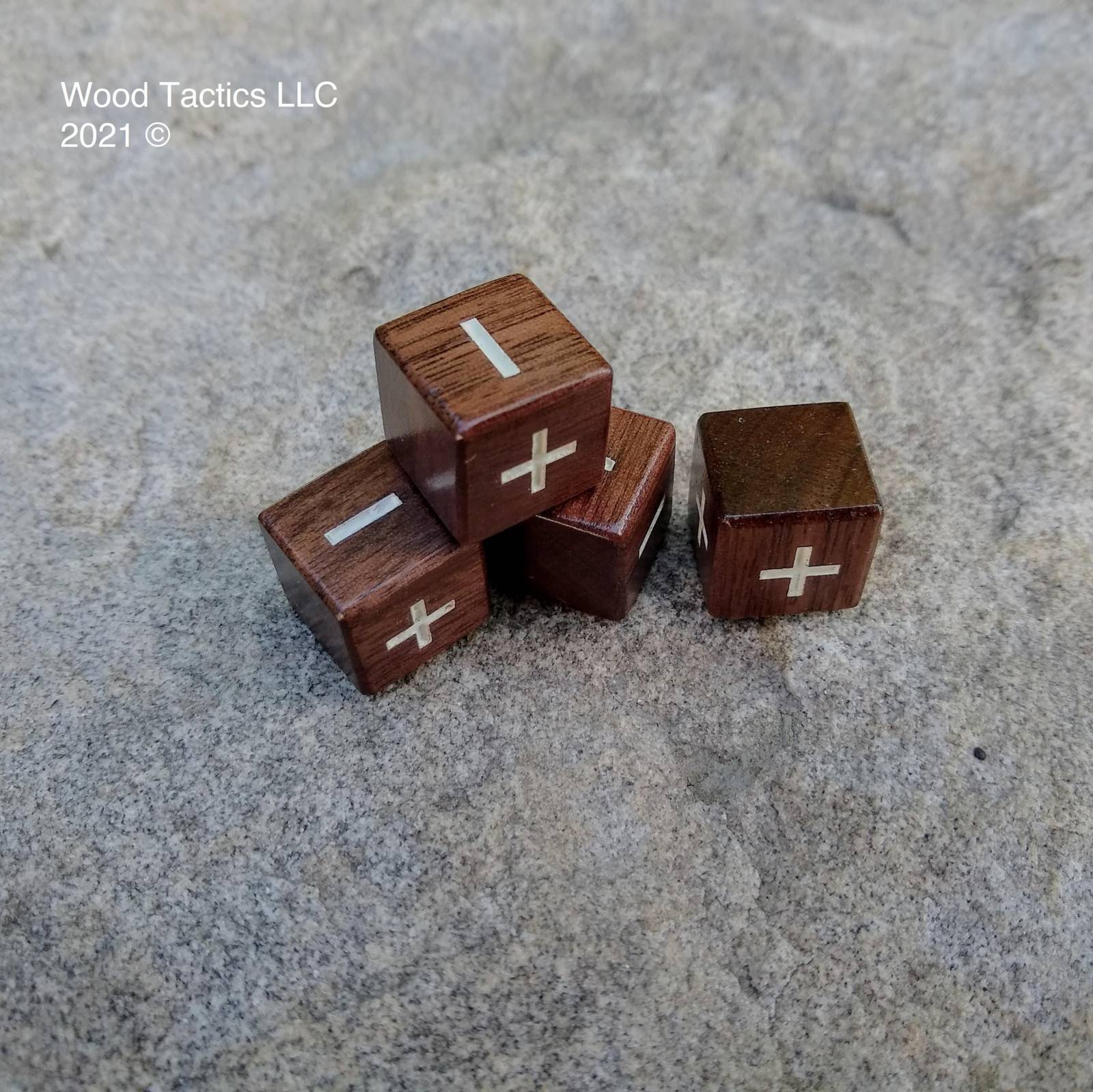 Walnut Hardwood D6 16mm in size Dice with Fate Symbols. Symbols are inked in white.