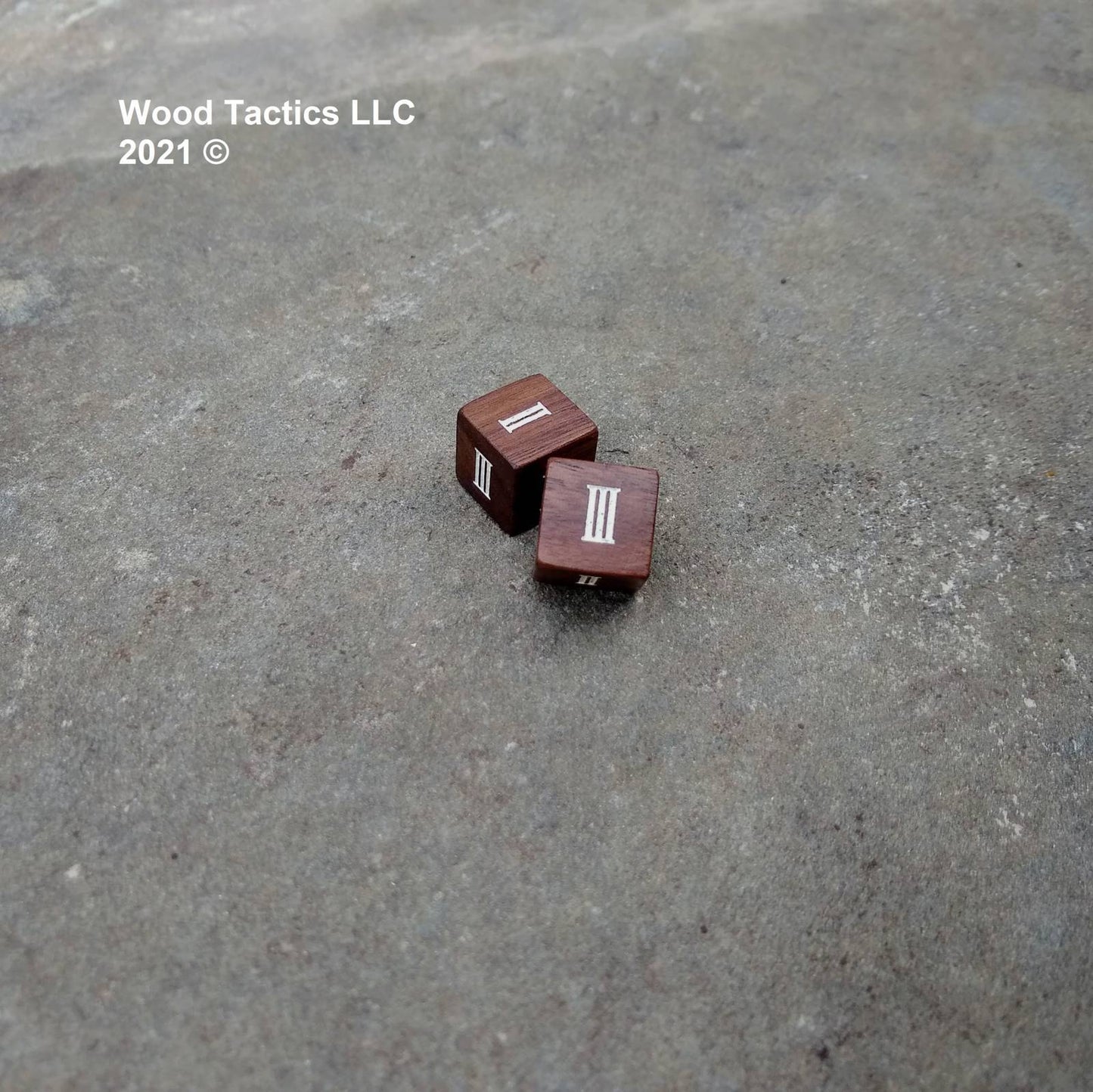 Walnut Hardwood D6 16mm in size Dice with Roman Numerals Symbols. Symbols are inked in white.