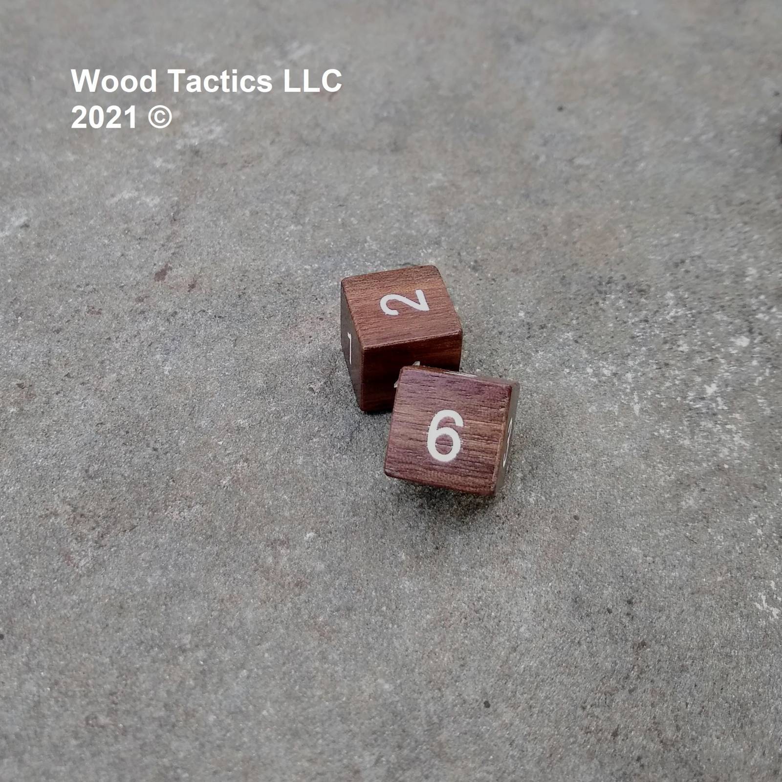 Walnut Hardwood D6 16mm in size Dice with Numbers Symbols. Symbols are inked in white.