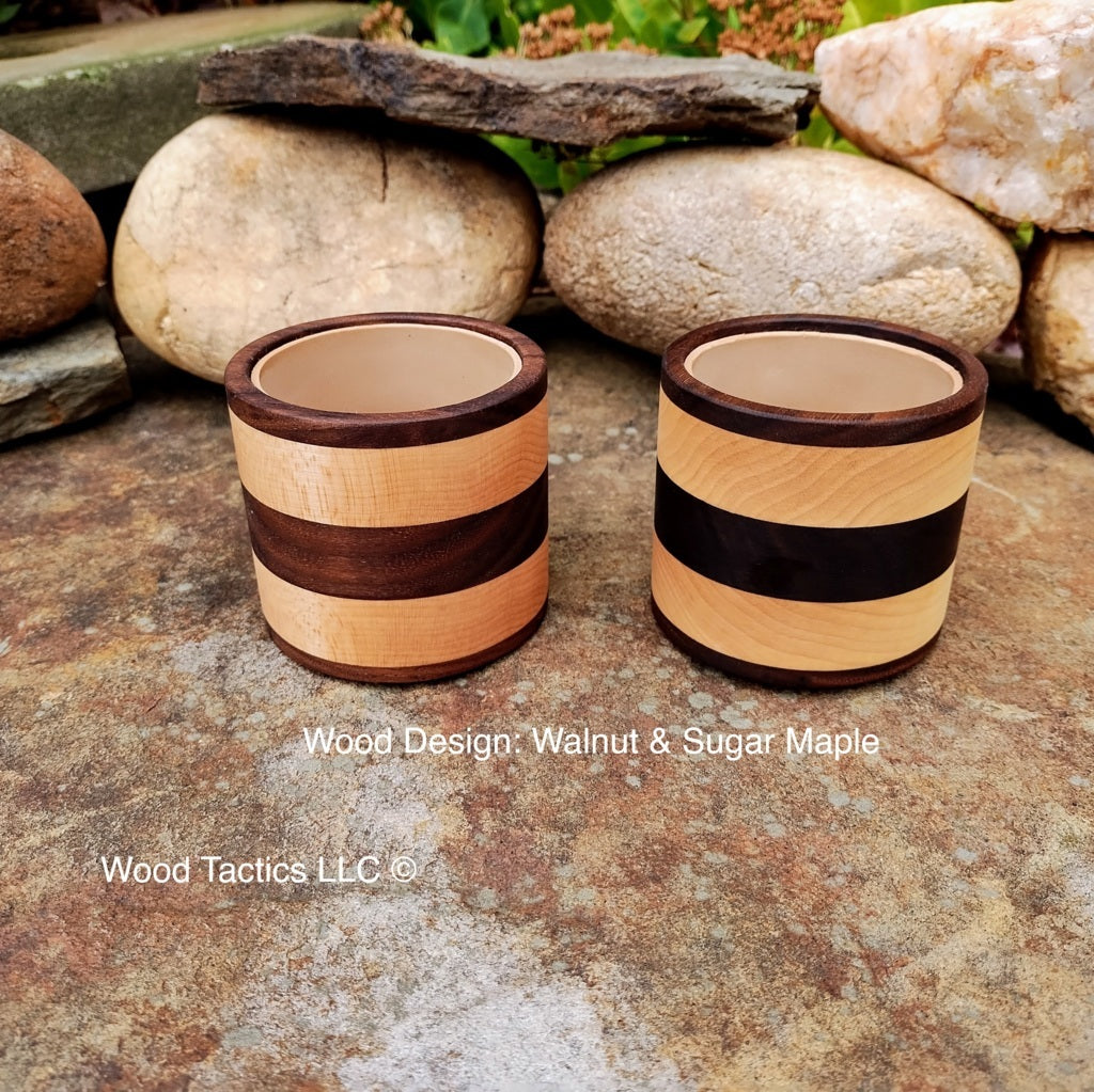 Walnut and maple hardwood dice cup with foam lining, featuring a sleek, striped design for quiet, cushioned rolls in style.